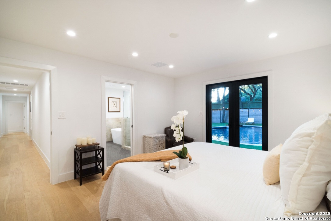 8900 Point W Drive Austin, TX 78759 - Photo 10 of 29 a bedroom with a bed and a large window