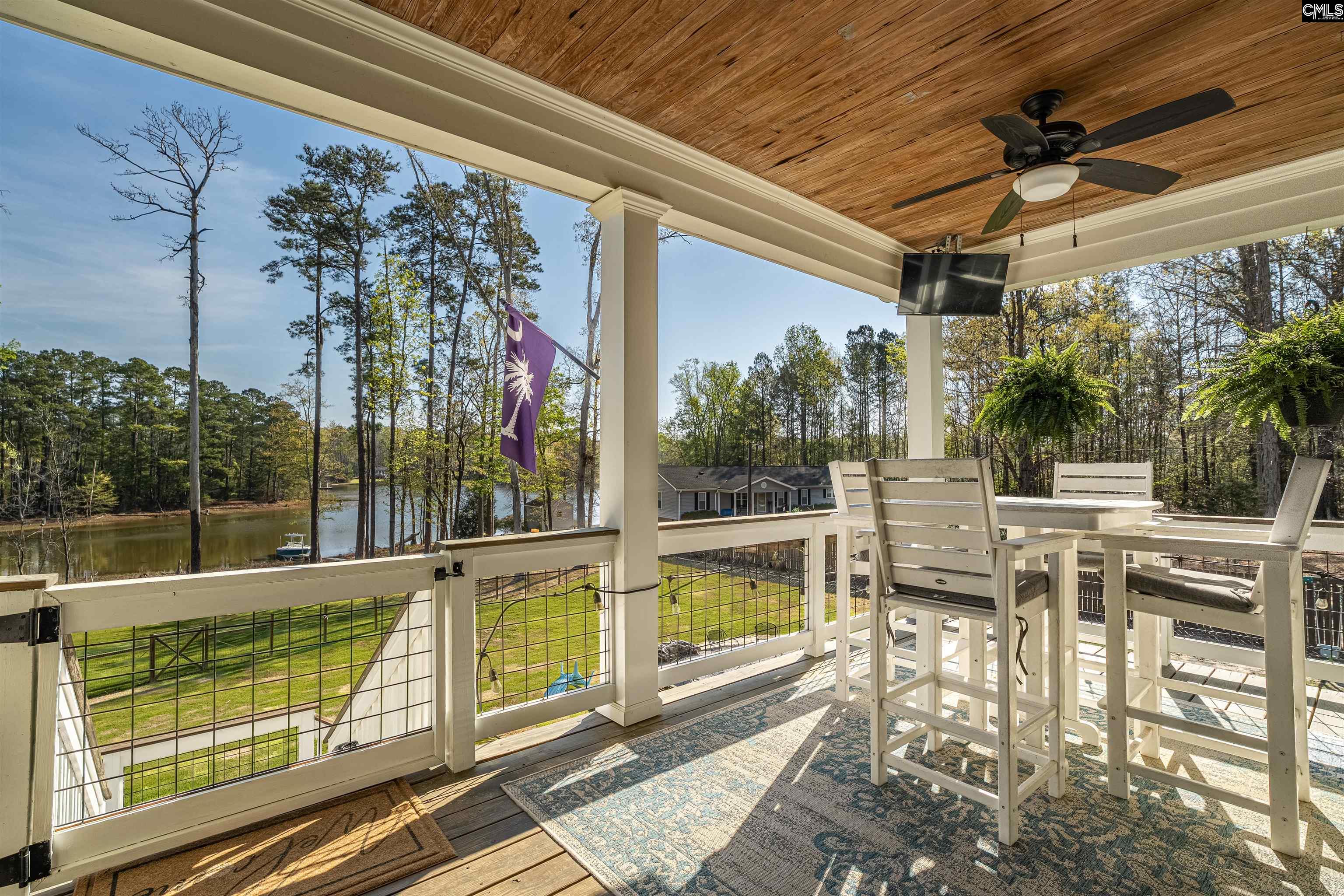 649 Sandbar Road Chapin, SC 29036 - Photo 2 of 40 a view of a patio with table and chairs and potted plants
