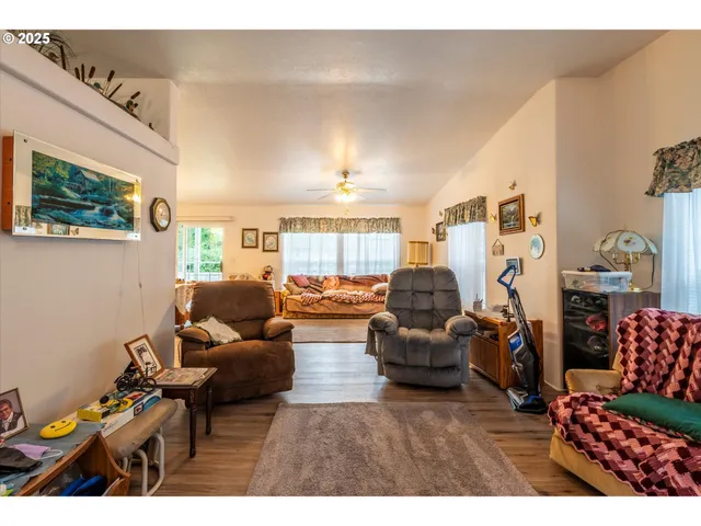 a living room with furniture and a painting on the wall