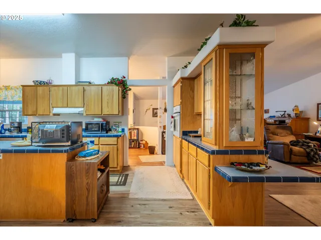 a kitchen with stainless steel appliances kitchen island granite countertop a sink and cabinets