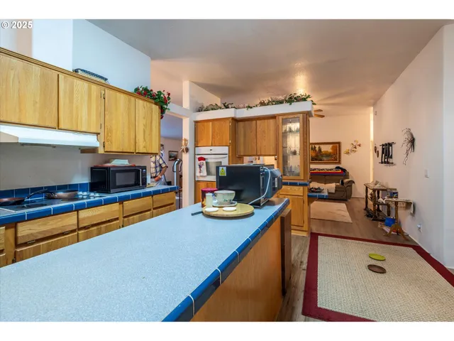 a kitchen with sink refrigerator and window