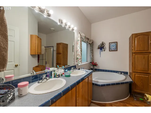a bathroom with a double vanity sink and a mirror