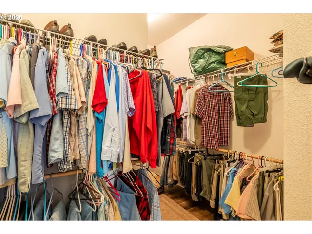 a view of walk in closet with clothes