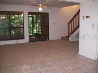 5734 Southwest 8th Place Gainesville, FL 32607 - Photo 7 of 18 a view of an entryway with a floor to ceiling window and stairs