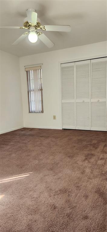 5734 Southwest 8th Place Gainesville, FL 32607 - Photo 8 of 18 an empty room with windows and fan