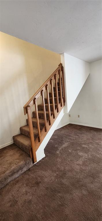 5734 Southwest 8th Place Gainesville, FL 32607 - Photo 10 of 18 a view of a big room with staircase