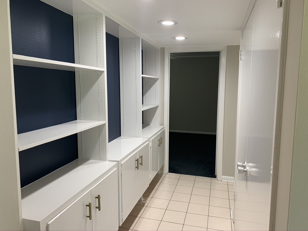 29229 Sheffield Road Waller, TX 77484 - Photo 11 of 16 The hall is equipped with these beautiful built in white cabinets and shelves perfectly accented with gold finishes.