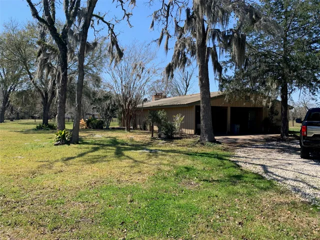 a view of a house with swimming pool and sitting area