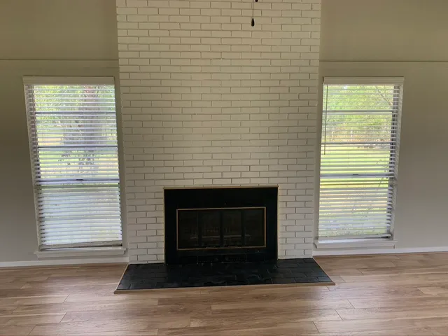a living room with a fireplace and a floor