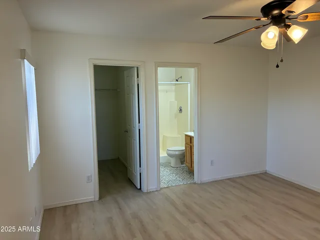 a view of a room with a hanging light and kitchen