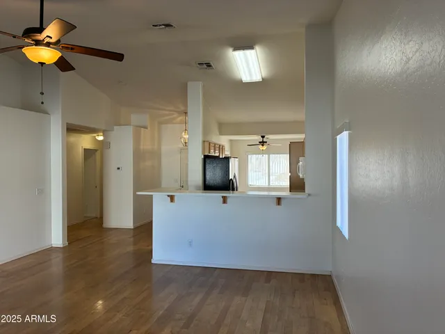 a view of kitchen with furniture and a chandelier fan
