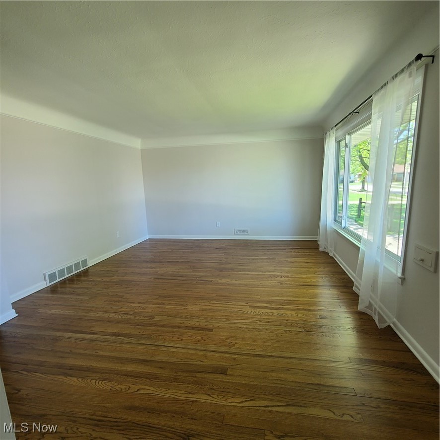 12204 Grannis Road Garfield Heights, OH 44125 - Photo 5 of 22 Spacious living room features lots of natural light and newly refinished hardwood flooring