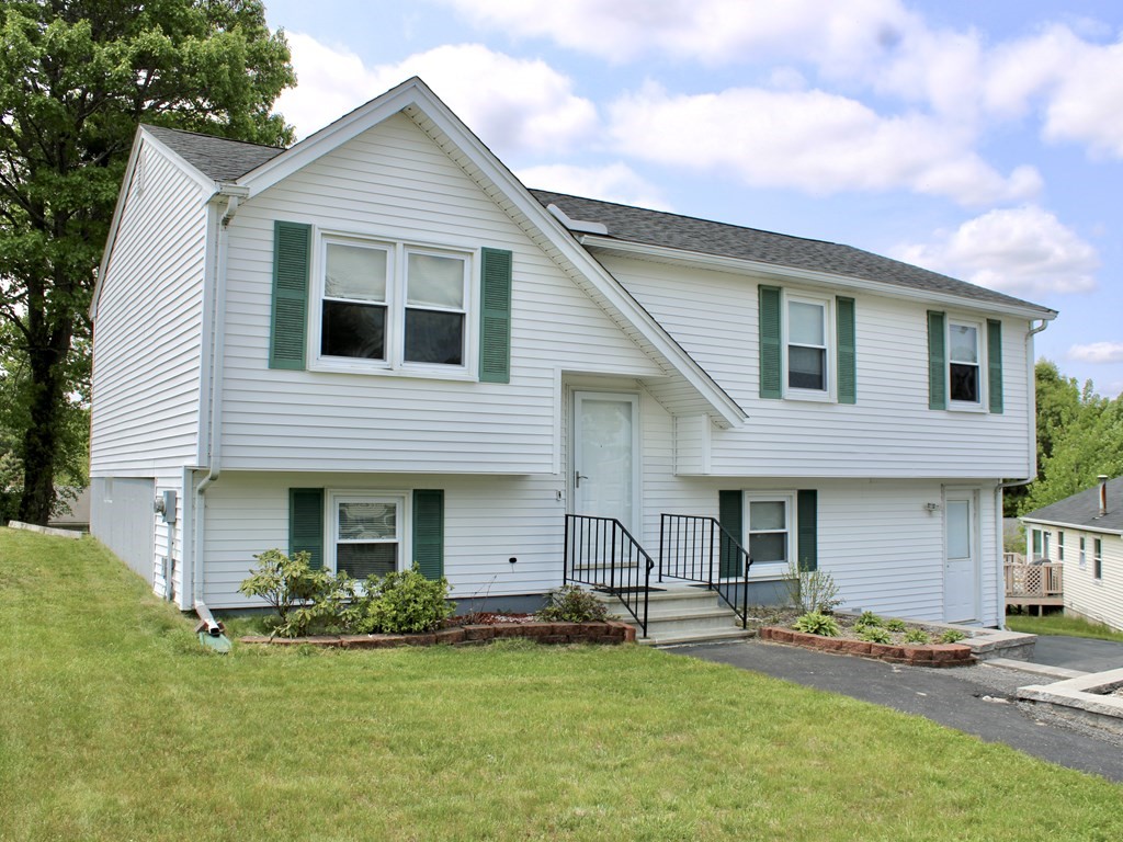 8 Timrod Drive Worcester, MA 01603 - Photo 1 of 9 a front view of a house with a garden and yard