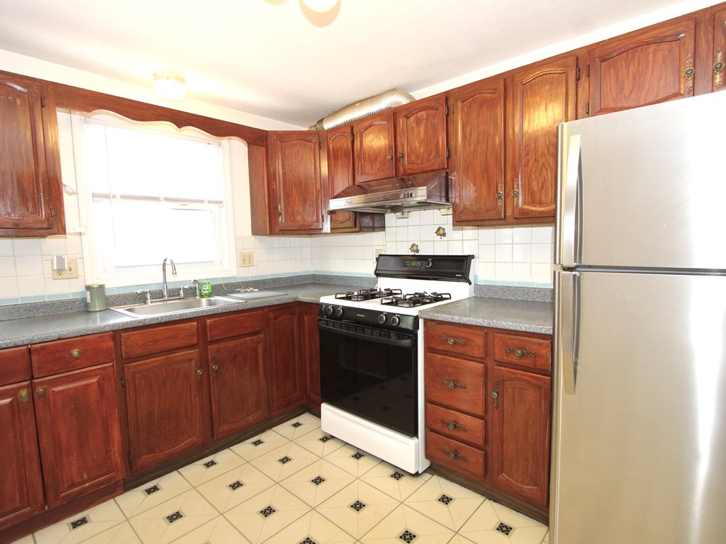8 Timrod Drive Worcester, MA 01603 - Photo 3 of 9 a kitchen with stainless steel appliances granite countertop a refrigerator sink and cabinets