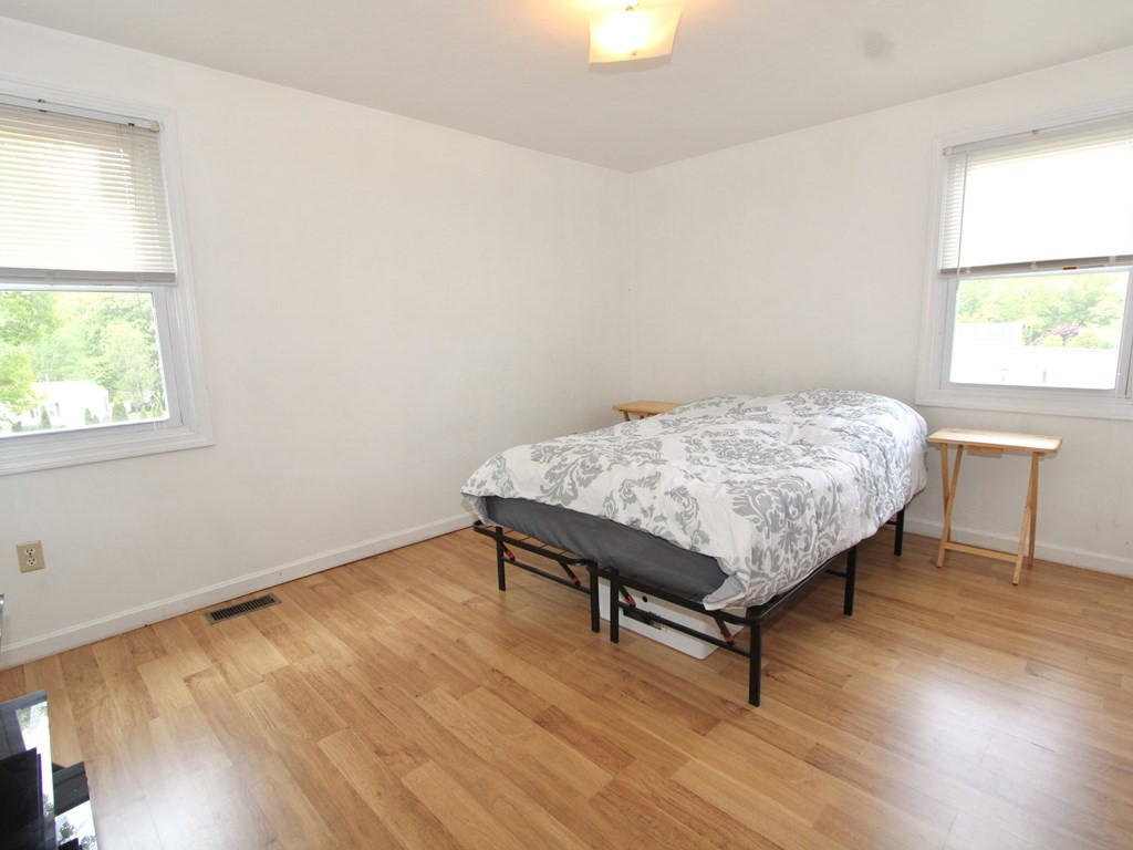 8 Timrod Drive Worcester, MA 01603 - Photo 5 of 9 a bedroom with a bed window and wooden floor