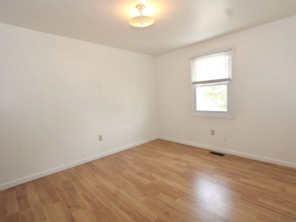 8 Timrod Drive Worcester, MA 01603 - Photo 6 of 9 an empty room with wooden floor and windows