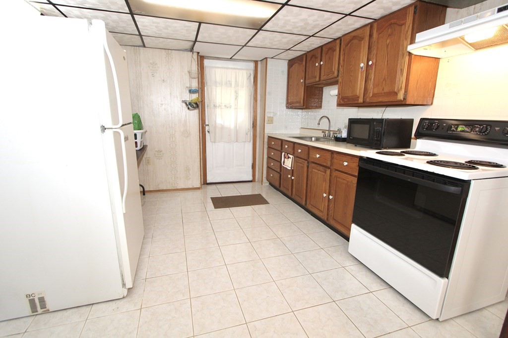 8 Timrod Drive Worcester, MA 01603 - Photo 7 of 9 a kitchen with stainless steel appliances granite countertop a refrigerator and a stove top oven