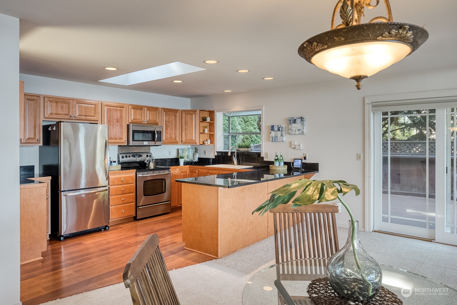 1161 Griffith Point Road Nordland, WA 98358 - Photo 15 of 38 a kitchen with stainless steel appliances granite countertop a refrigerator a sink a stove a dining table and chairs