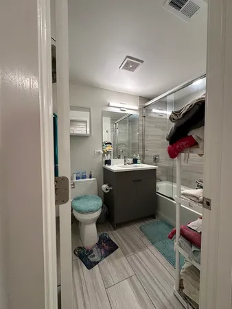 a bathroom with a sink mirror vanity and toilet