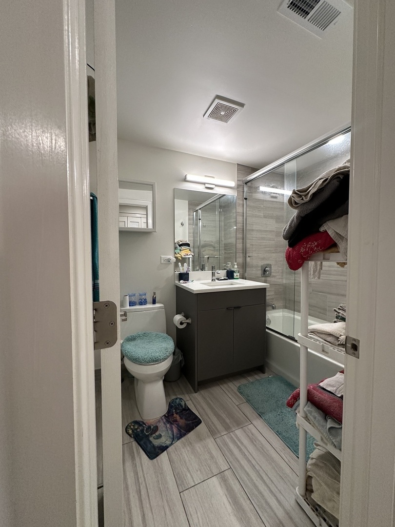 2329 West Monroe Street, Unit LW Chicago, IL 60612 - Photo 15 of 16 a bathroom with a sink mirror vanity and toilet