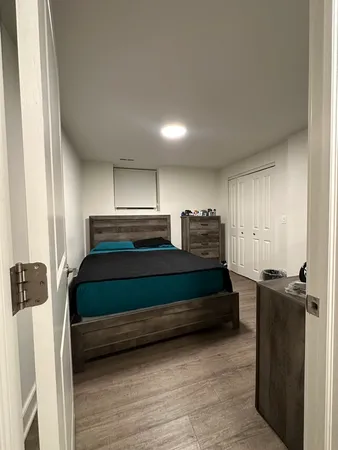 a bedroom with a bed and a closet