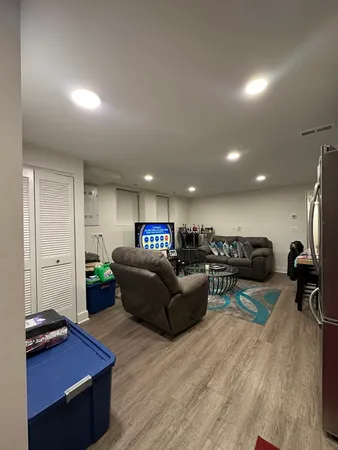 a living room with furniture and a wooden floor