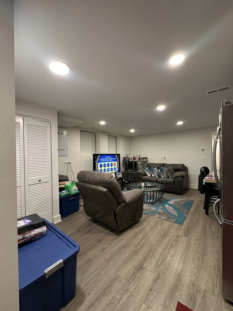 2329 West Monroe Street, Unit LW Chicago, IL 60612 - Photo 5 of 16 a living room with furniture and a wooden floor