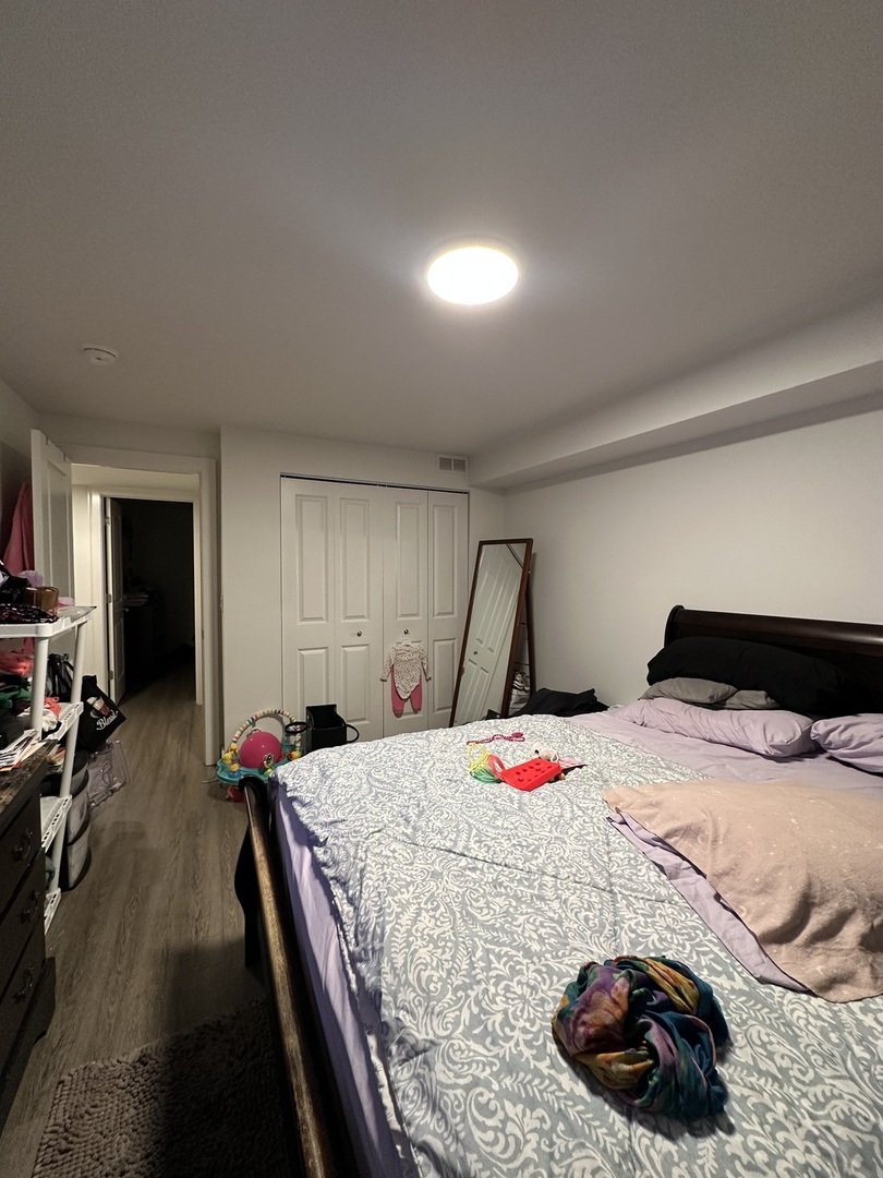 2329 West Monroe Street, Unit LW Chicago, IL 60612 - Photo 7 of 16 a bed room with a bed and a couch