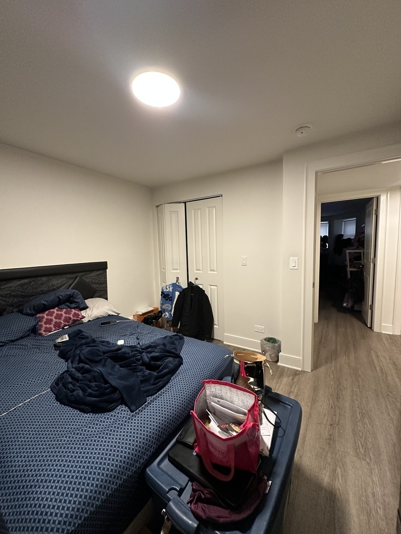 2329 West Monroe Street, Unit LW Chicago, IL 60612 - Photo 9 of 16 a bedroom with furniture and a wooden floor