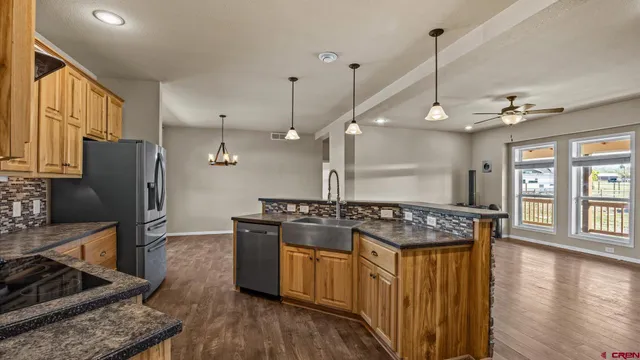 a kitchen with stainless steel appliances granite countertop a stove and refrigerator