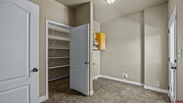 a view of walk in closet with empty racks