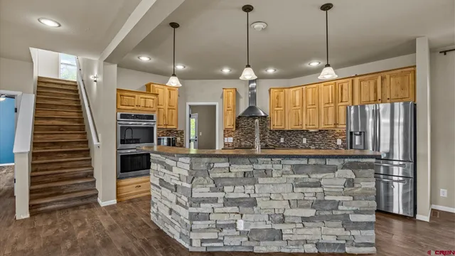 a view of a kitchen with a sink and a window