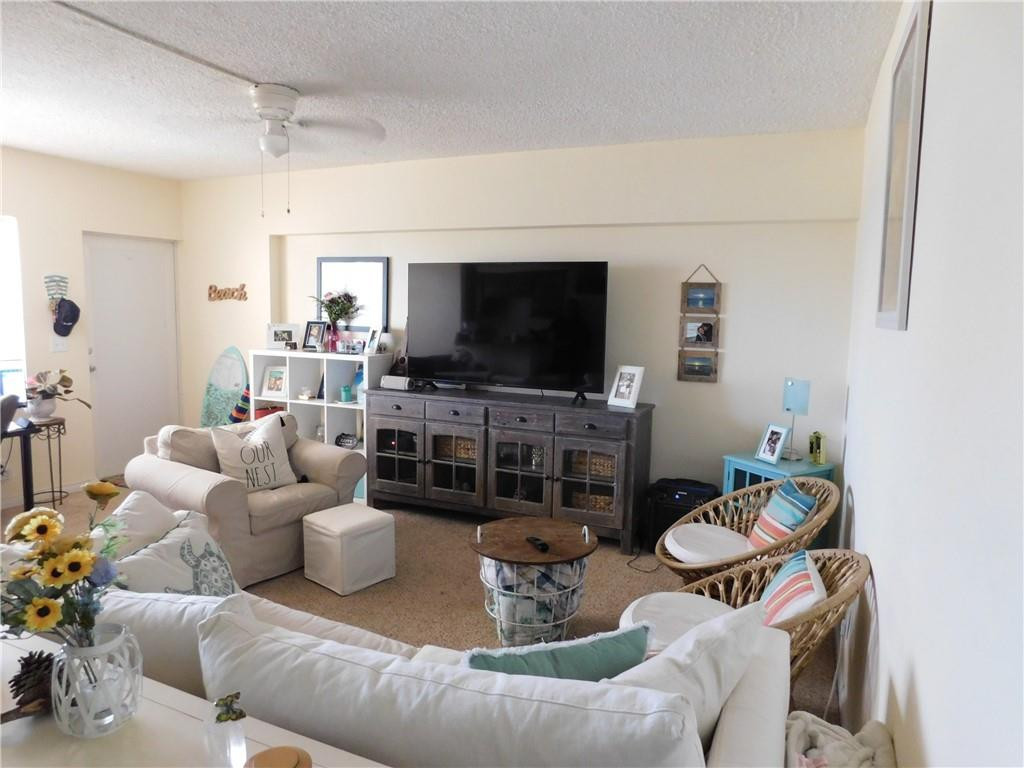 901 South Surf Road, Unit 306 Hollywood, FL 33019 - Photo 13 of 44 a living room with furniture and a flat screen tv