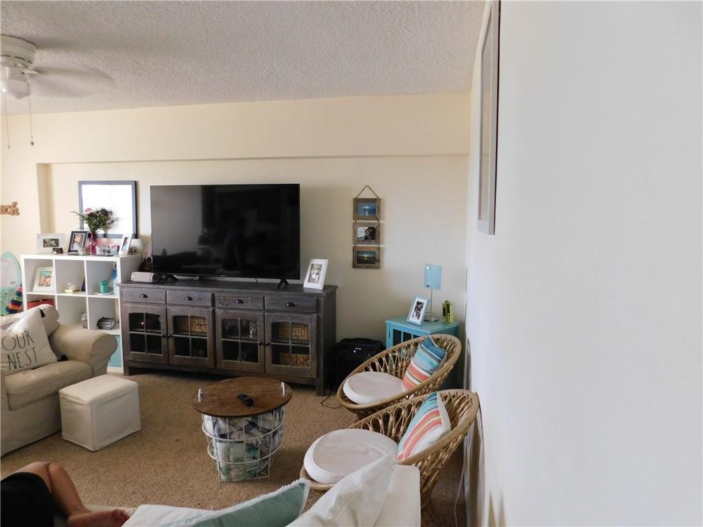 901 South Surf Road, Unit 306 Hollywood, FL 33019 - Photo 15 of 44 a living room with furniture and a flat screen tv