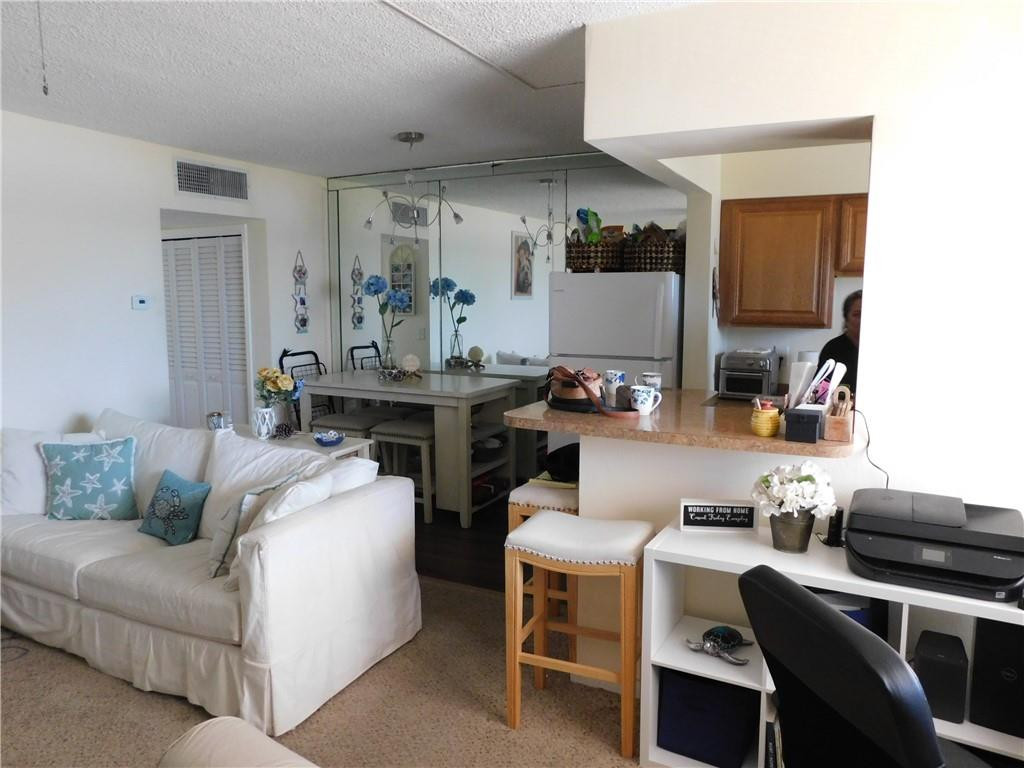 901 South Surf Road, Unit 306 Hollywood, FL 33019 - Photo 16 of 44 a living room with furniture and a kitchen