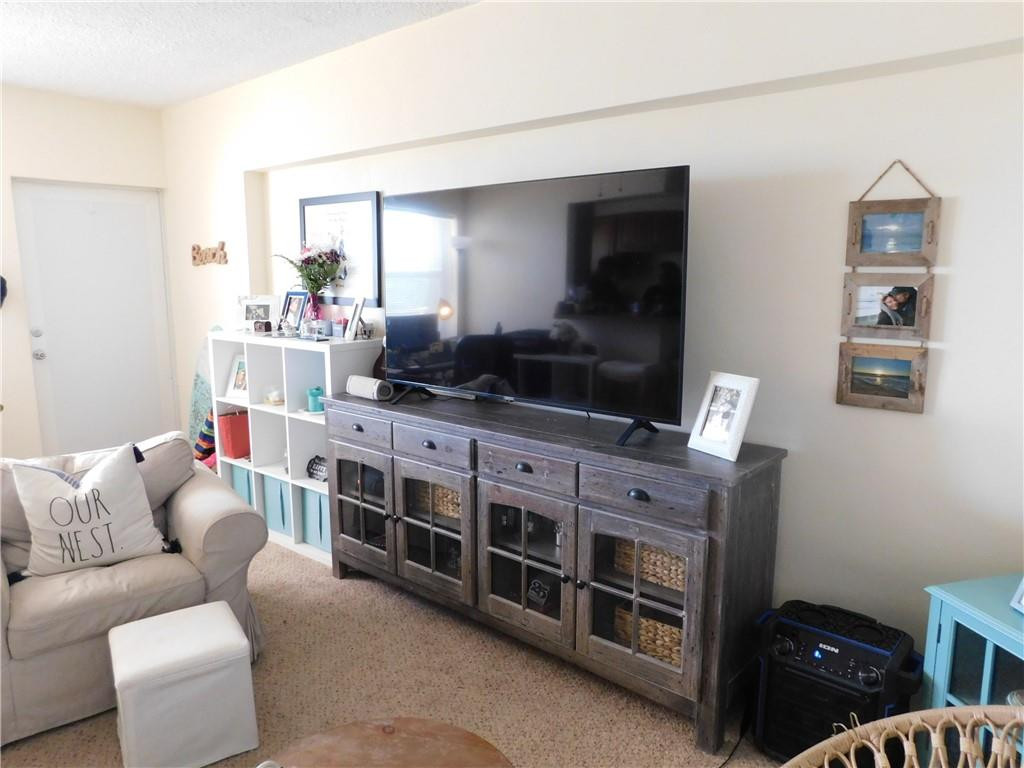 901 South Surf Road, Unit 306 Hollywood, FL 33019 - Photo 18 of 44 a living room with furniture and a flat screen tv