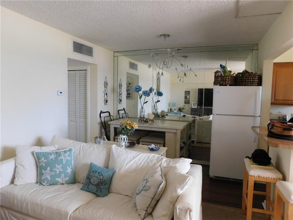 901 South Surf Road, Unit 306 Hollywood, FL 33019 - Photo 20 of 44 a living room with furniture a refrigerator and a table