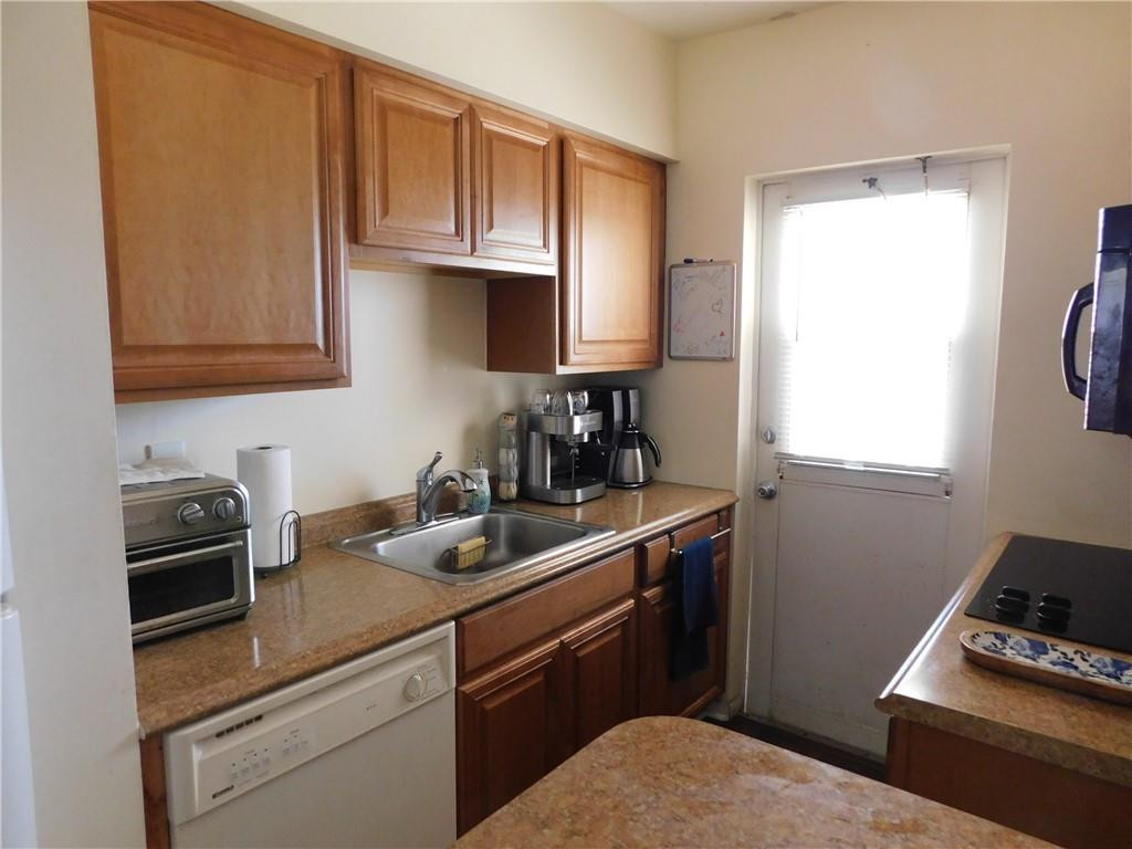 901 South Surf Road, Unit 306 Hollywood, FL 33019 - Photo 21 of 44 a kitchen with a sink cabinets and a window