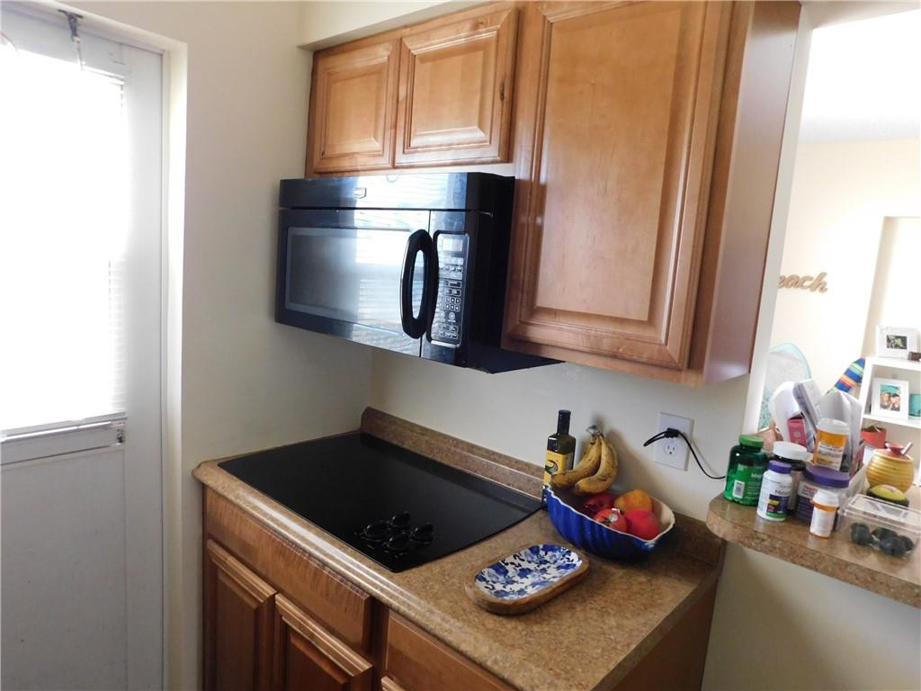 901 South Surf Road, Unit 306 Hollywood, FL 33019 - Photo 22 of 44 a kitchen with stainless steel appliances granite countertop a stove a microwave a sink and cabinets