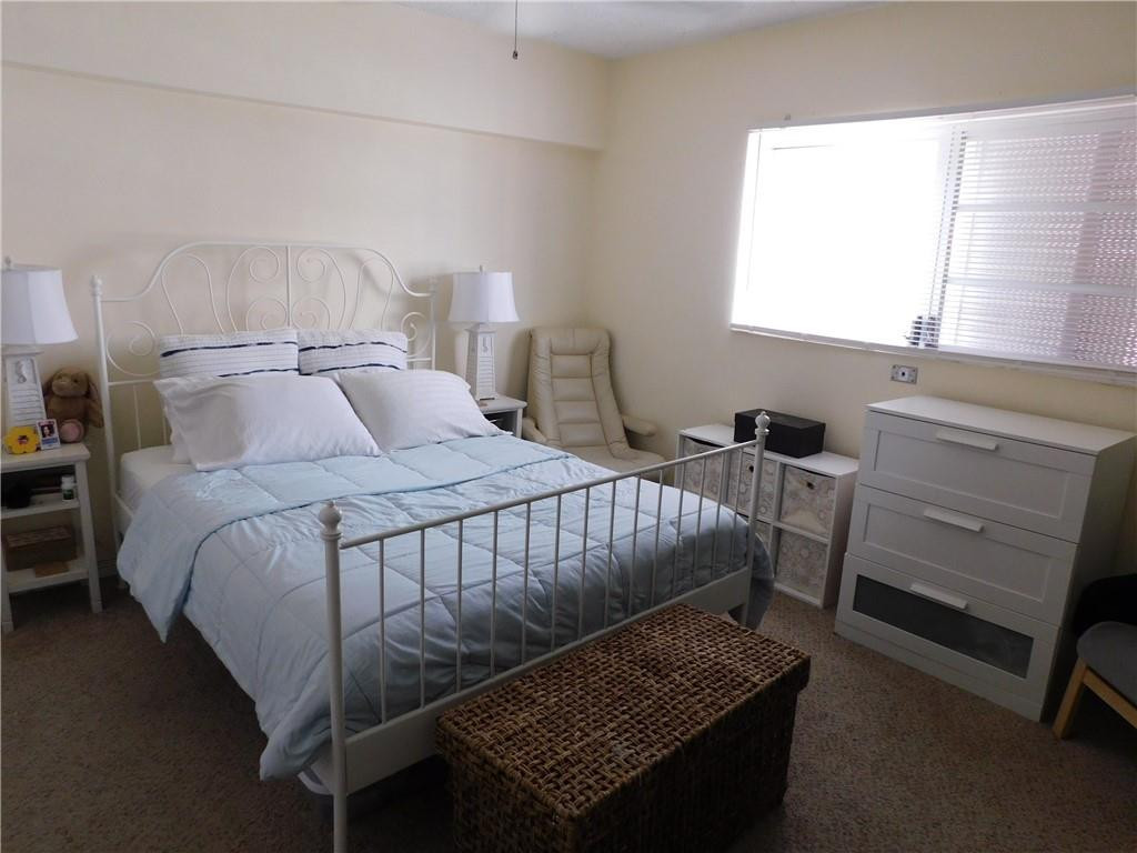 901 South Surf Road, Unit 306 Hollywood, FL 33019 - Photo 25 of 44 a bedroom with a bed and a window