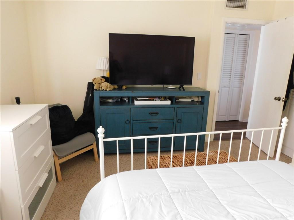 901 South Surf Road, Unit 306 Hollywood, FL 33019 - Photo 27 of 44 a bedroom with furniture and flat screen tv