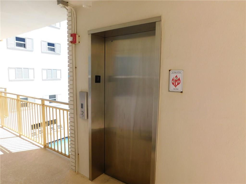 901 South Surf Road, Unit 306 Hollywood, FL 33019 - Photo 31 of 44 a view of a hallway with a white walls