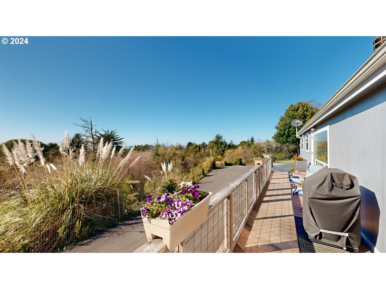 32877 Hillside Acres Road Gold Beach, OR 97444 - Photo 34 of 43 a backyard of a house with table and chairs