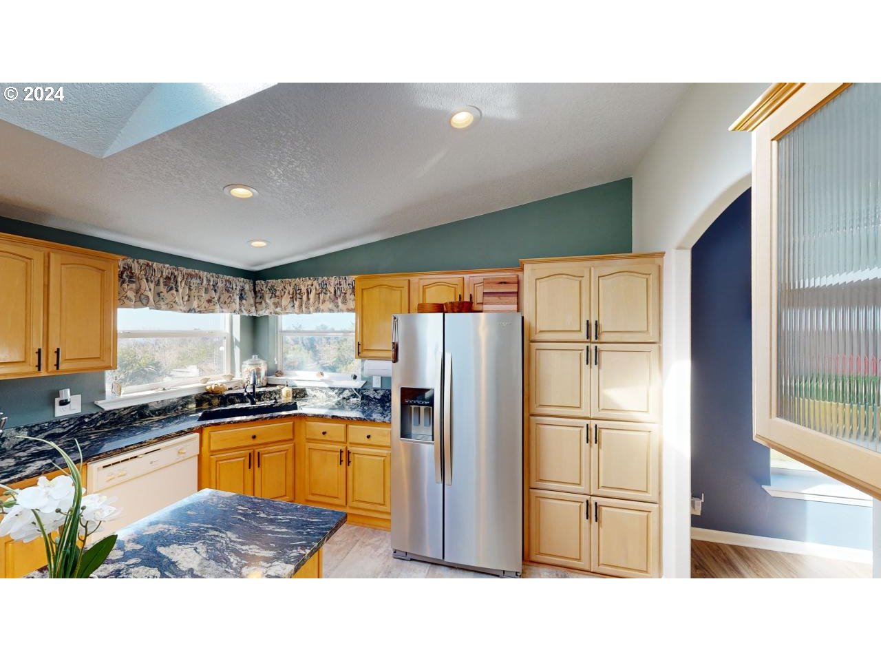 32877 Hillside Acres Road Gold Beach, OR 97444 - Photo 8 of 43 a kitchen with stainless steel appliances granite countertop a refrigerator a sink a stove and island
