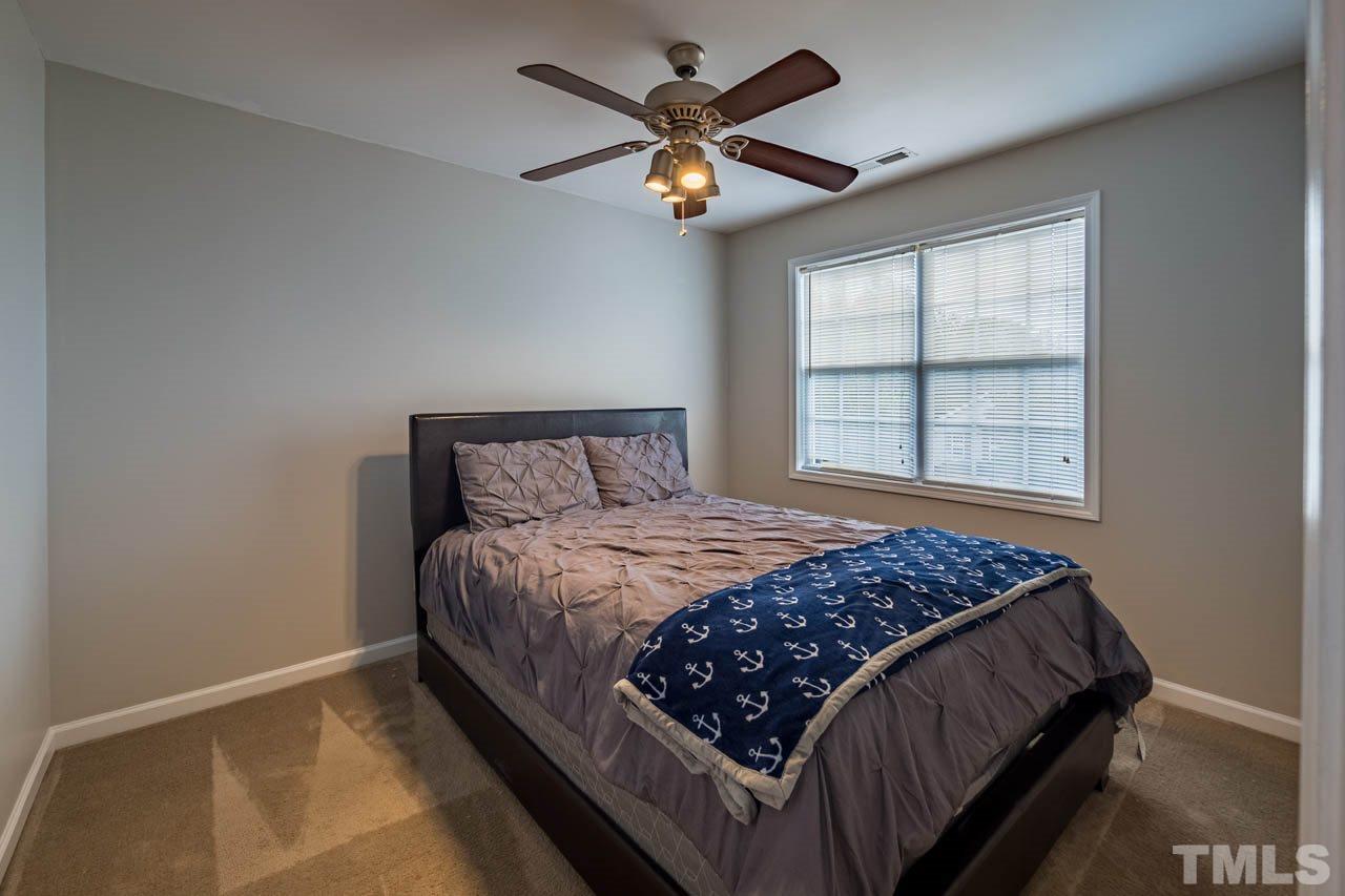 4917 Windproof Way Raleigh, NC 27616 - Photo 12 of 18 a bedroom with a bed and window