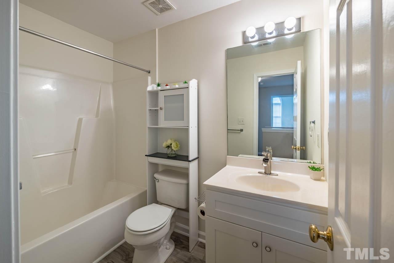 4917 Windproof Way Raleigh, NC 27616 - Photo 14 of 18 a bathroom with a sink toilet and shower