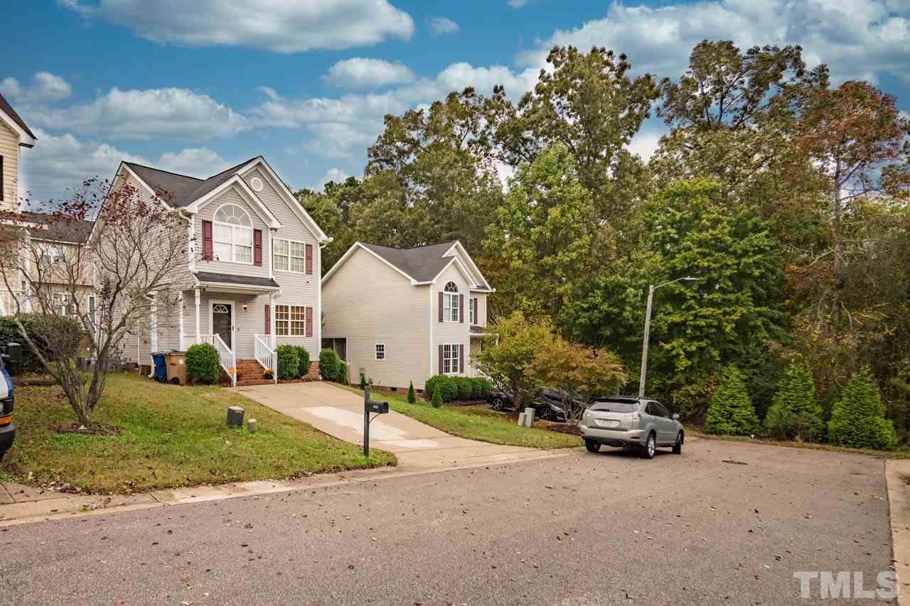4917 Windproof Way Raleigh, NC 27616 - Photo 16 of 18 a front view of a house with a yard and trees