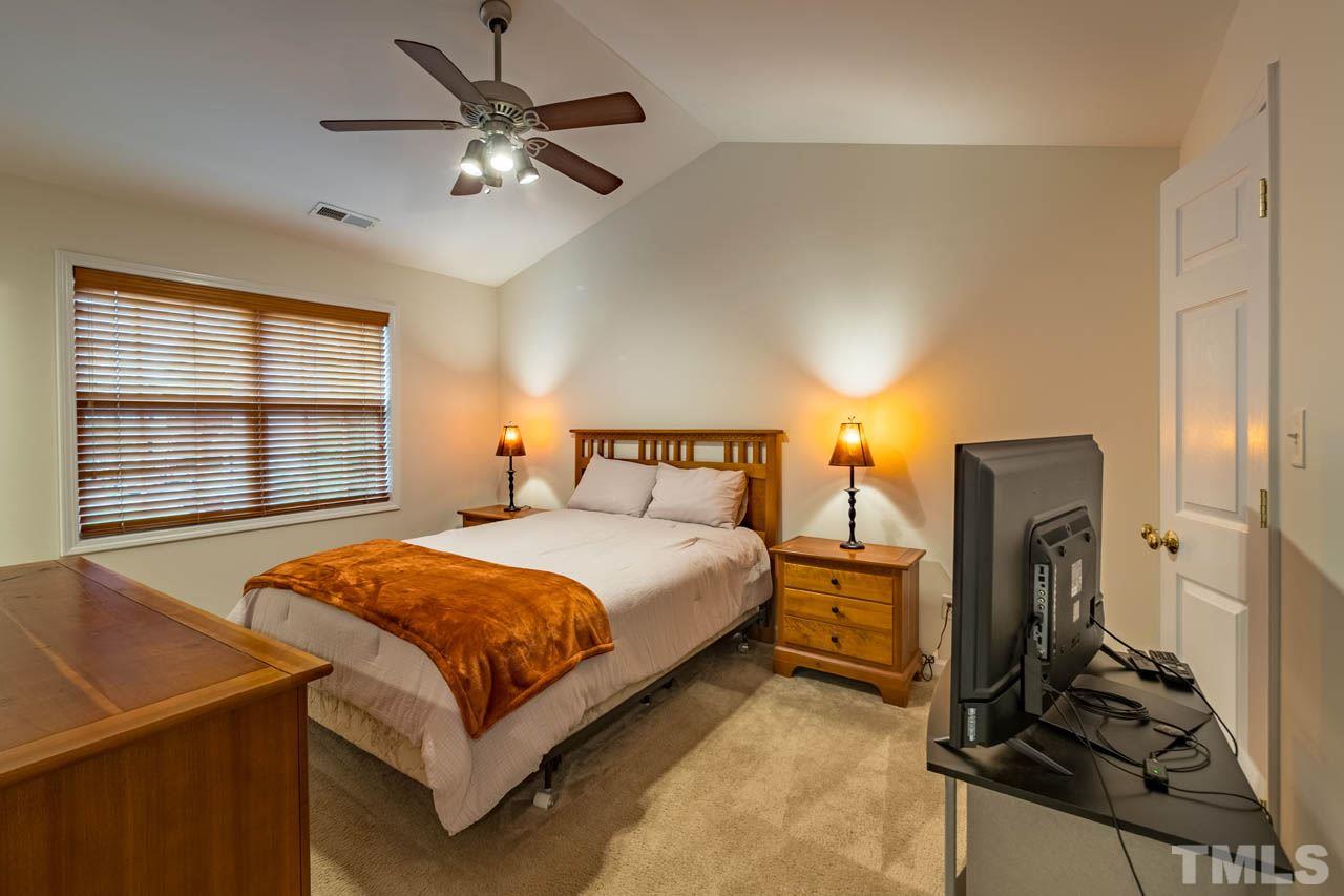 4917 Windproof Way Raleigh, NC 27616 - Photo 8 of 18 a bedroom with a bed and dresser