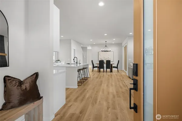 a living room with furniture dining table and a large window