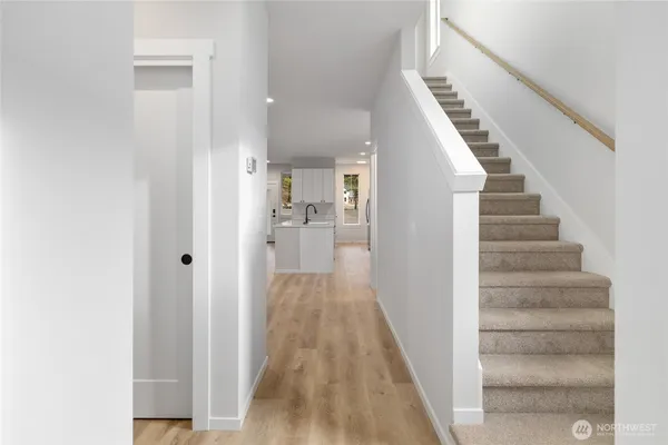 a kitchen with white cabinets and sink